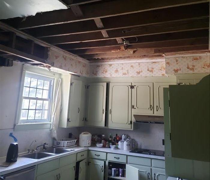 kitchen with large hole in ceiling