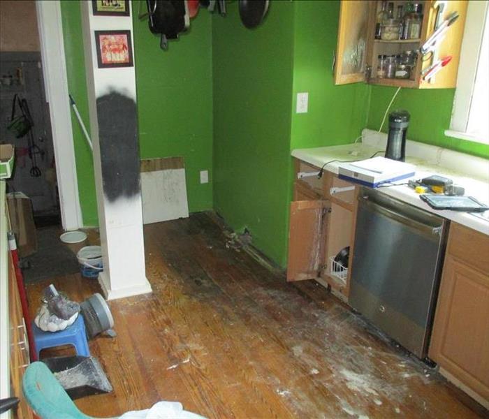 water-damaged hardwood floor in kitchen