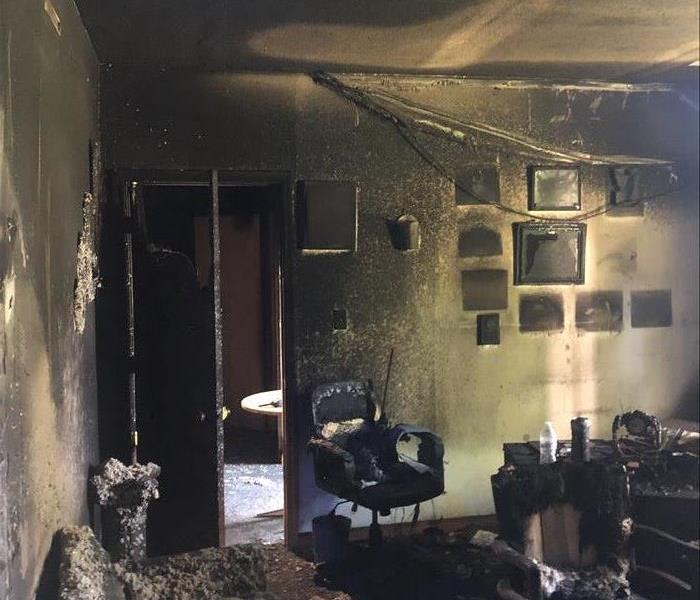 Pastor's office in church, walls are severely charred, insulation has fallen from overhead
