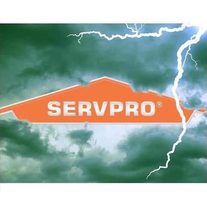 storm clouds with lightning, SERVPRO logo in the middle