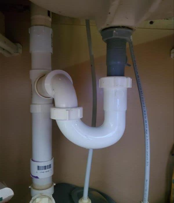 In the picture is piping underneath a bathroom sink a slow leak may become unnoticed unless checked regularly.